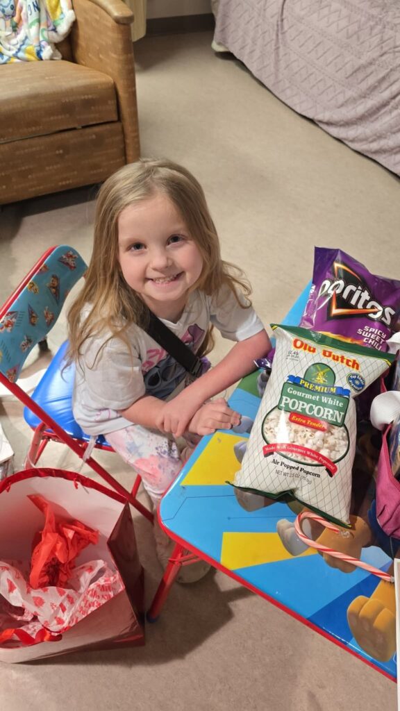 Evelyn all smiles after receiving a blood transfusion and digging into her favorite snacks