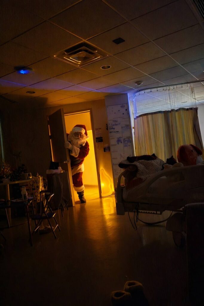 santa coming into hospital room to deliver toys