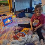 Evelyn inside a blanket fort